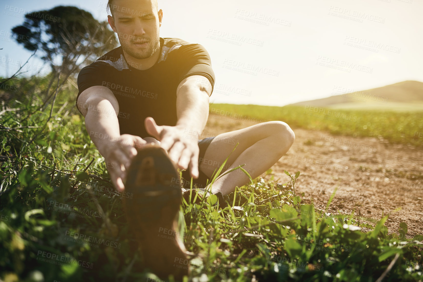 Buy stock photo Runner, grass or man stretching legs for training, exercise or fitness workout in countryside nature. Muscle warm up, healthy or sports athlete ready to start practice for wellness, body or running