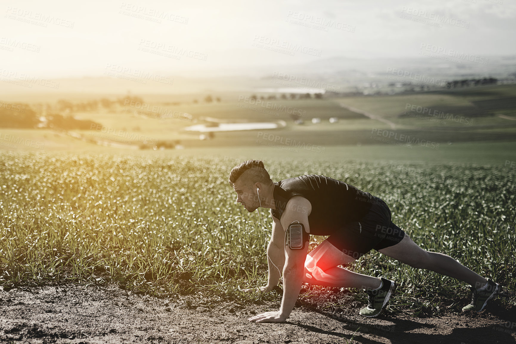 Buy stock photo Man, start and knee pain for running, outdoor and bone or joint injury in countryside or arthritis. Male person, athlete ready and osteoarthritis or stress tension on body, red glow and inflammation