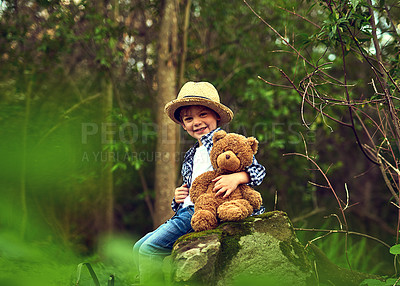 Buy stock photo Happy, young boy and teddy bear in forest for adventure with straw hat outdoor in nature. Excited, male kid and stuffed animal in woods with trees for fun, relax and exploration or discovery 