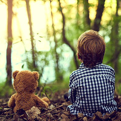 Buy stock photo Young boy, teddy bear and back for outdoor adventure in forest for exploration with companion in nature. Calm, male kid and stuffed animal in woods fun, relax and discovery with friends for growth