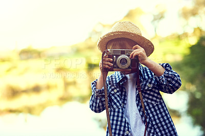 Buy stock photo Shot of a little boy holding a camera