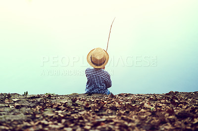 Buy stock photo Rearview shot of a little boy fishing in the forest