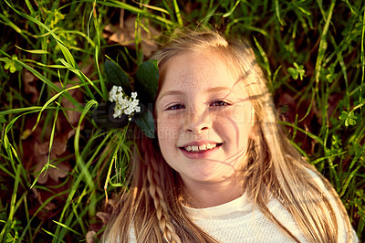 Buy stock photo Girl, child and relax on grass with portrait outdoor for fun or playing, fresh air and enjoyment of youth or childhood in summer. Female kid, happy and nature in afternoon for carefree and adventure.