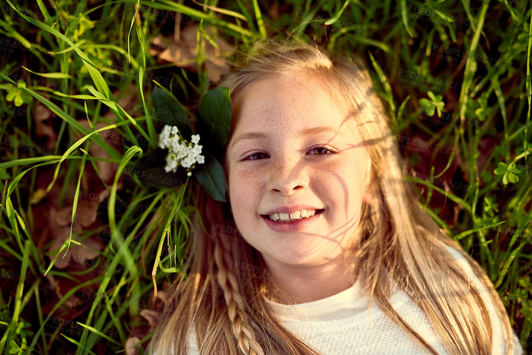 Buy stock photo Girl, child and relax on grass with portrait outdoor for fun or playing, fresh air and enjoyment of youth or childhood in summer. Female kid, happy and nature in afternoon for carefree and adventure.