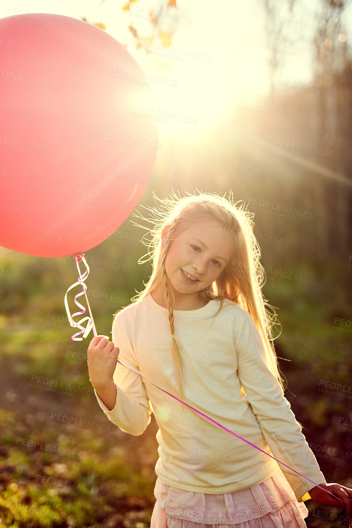 Buy stock photo Portrait, balloon and sunlight for girl in forest, nature and park for birthday party in woods. Childhood development, celebration and smile for young child person, happy and relax or play in grass