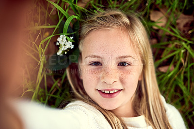 Buy stock photo Girl, kid and selfie on grass with portrait outdoor for fun or playing, fresh air and enjoyment of youth or childhood in summer. Female child, happy and photography in nature for memory and adventure