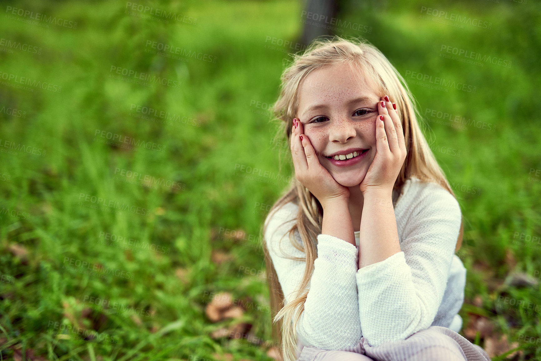 Buy stock photo Girl, child and happy on grass with portrait outdoor for fun or playing, fresh air and enjoyment of youth or childhood in summer. Female kid, relax and nature in afternoon for carefree and adventure.