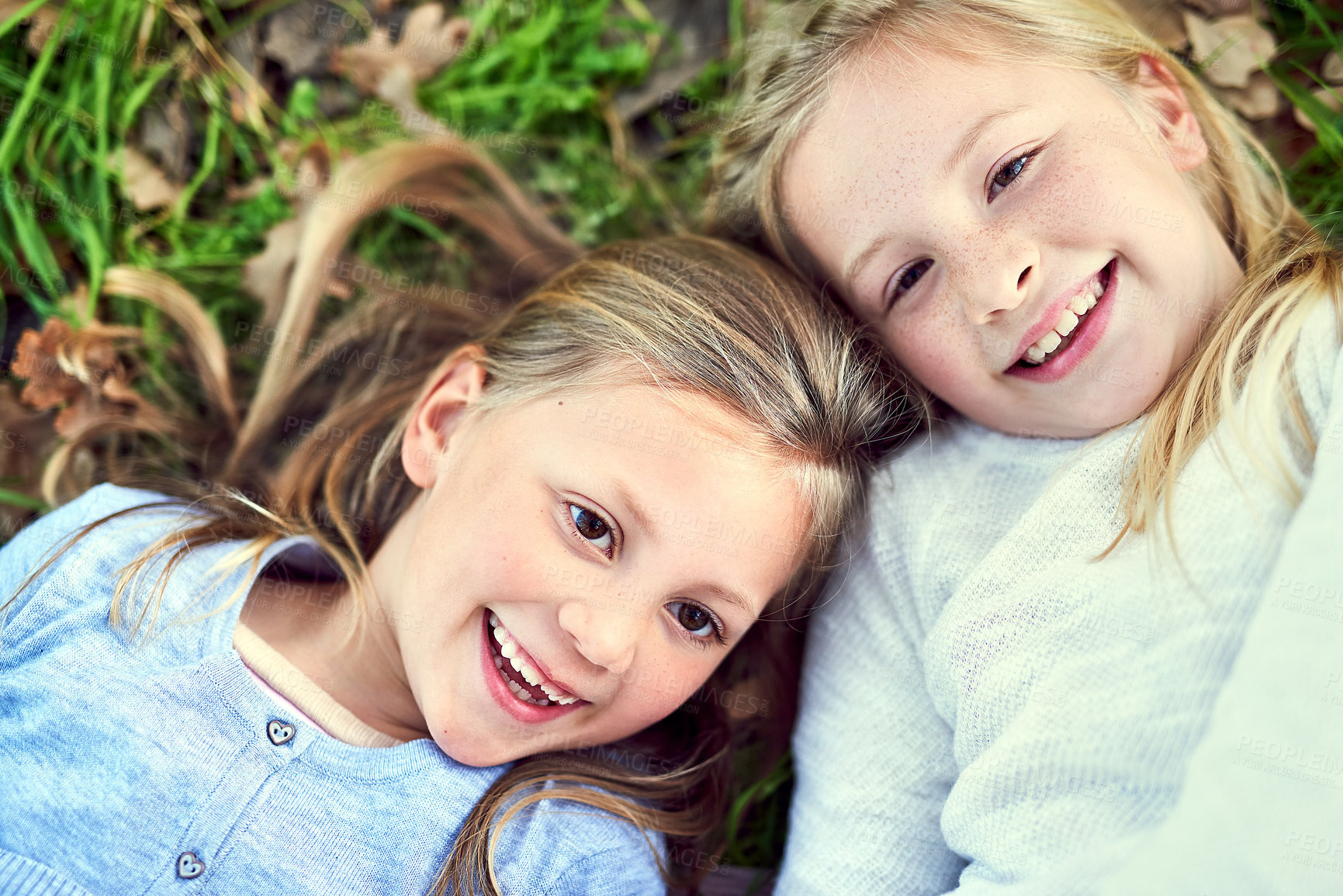 Buy stock photo Top view, portrait and kids laughing on grass outdoor for bonding, play and family relax at park. Above, face and happy children on lawn, girls and funny sisters together at garden on summer holiday