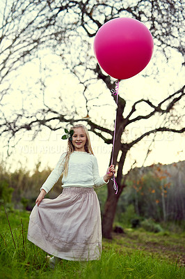 Buy stock photo Portrait, balloon and sunlight for girl in forest, nature and park for birthday party in woods. Childhood development, celebration and smile for young child person, happy and relax or play in grass