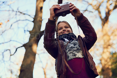 Buy stock photo Shot of a young girl taking a selfie with a vintage camera outdoors