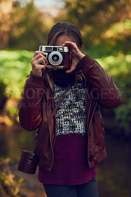 Buy stock photo Vintage camera, outdoor and girl in park, photography and memory with picture, sunshine and adventure. Person, photographer or explore for journey, hobby or activity in forest, weekend break or retro