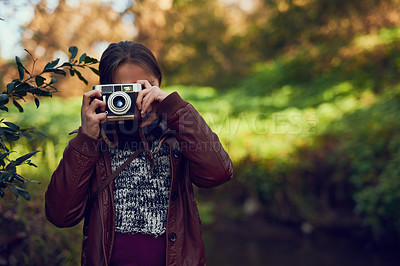 Buy stock photo Shot of a young girl taking pictures with a vintage camera outdoors