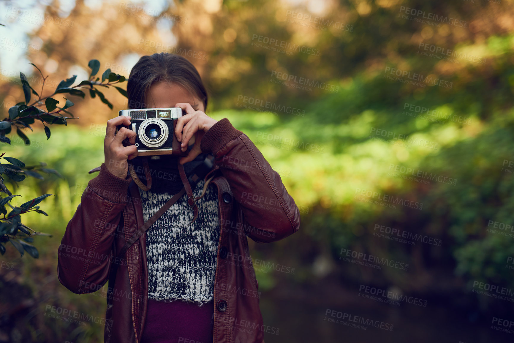 Buy stock photo Shot of a young girl taking pictures with a vintage camera outdoors