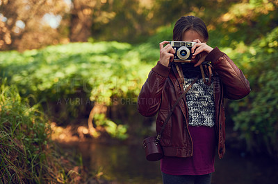 Buy stock photo Shot of a young girl taking pictures with a vintage camera outdoors