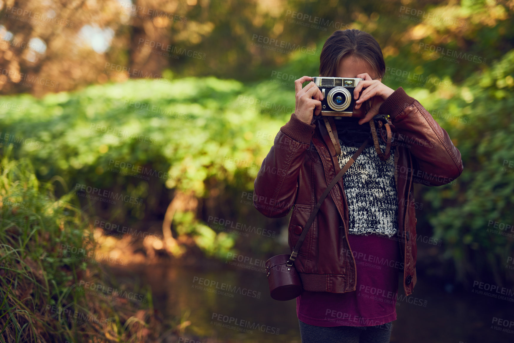 Buy stock photo Shot of a young girl taking pictures with a vintage camera outdoors