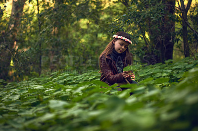 Buy stock photo Shot of a little girl playing outdoors in a forest