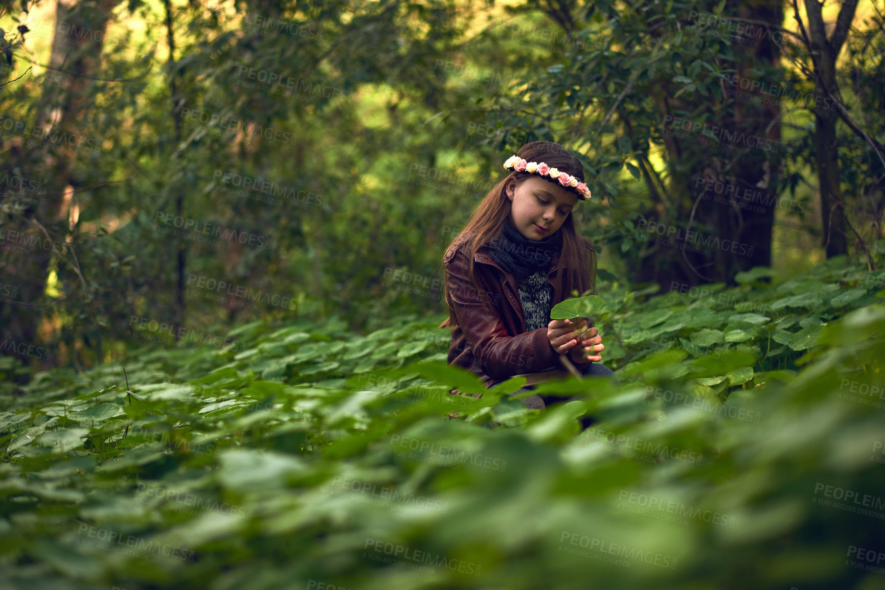 Buy stock photo Shot of a little girl playing outdoors in a forest