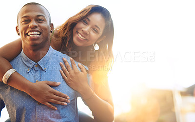 Buy stock photo Portrait of a happy young couple enjoying a piggyback ride outdoors