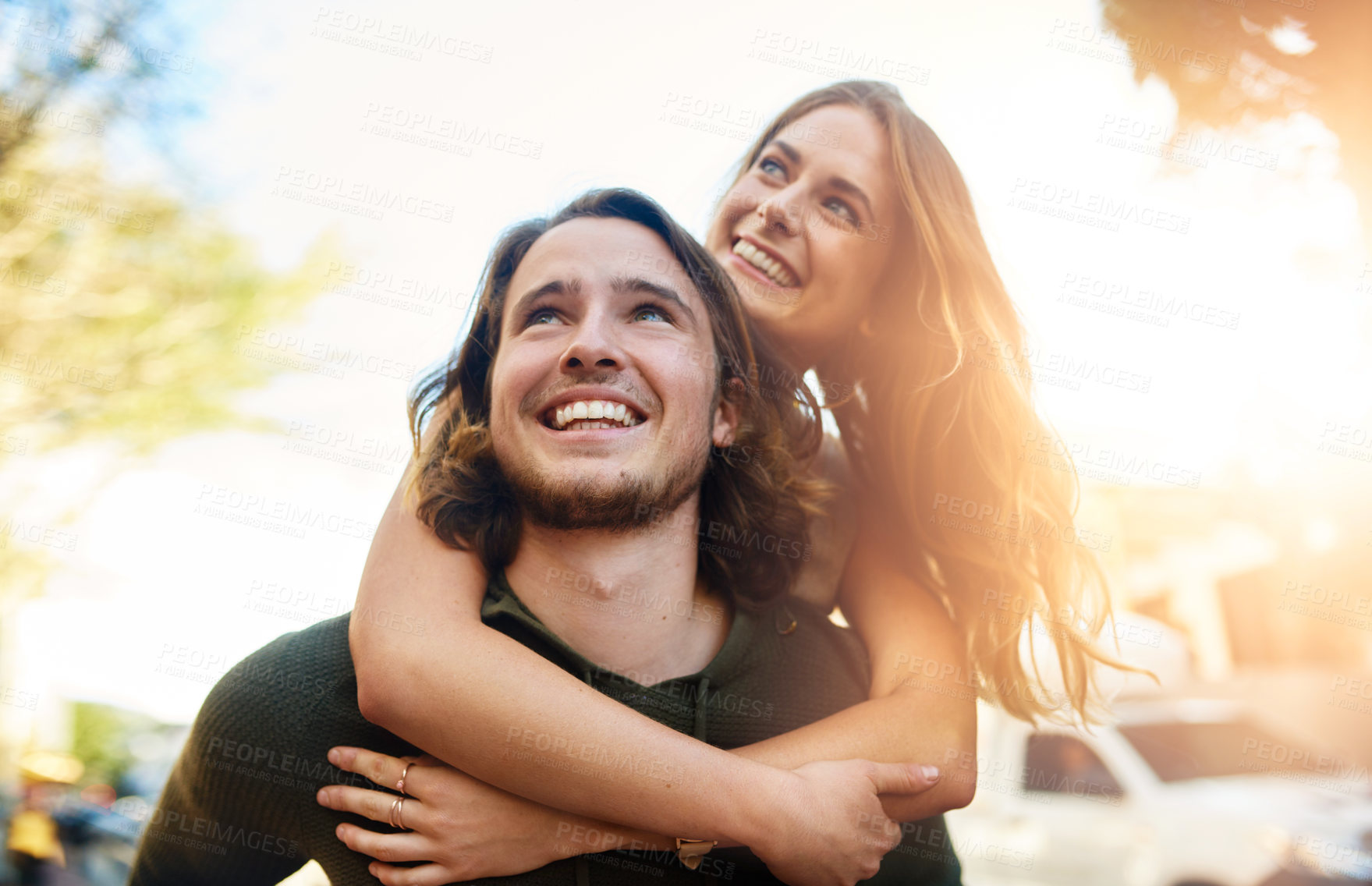 Buy stock photo Piggyback, travel and happy couple in city together for relationship, bonding or tourism for weekend break. Smile, outdoor and people in urban town street for adventure, holiday or vacation in Miami