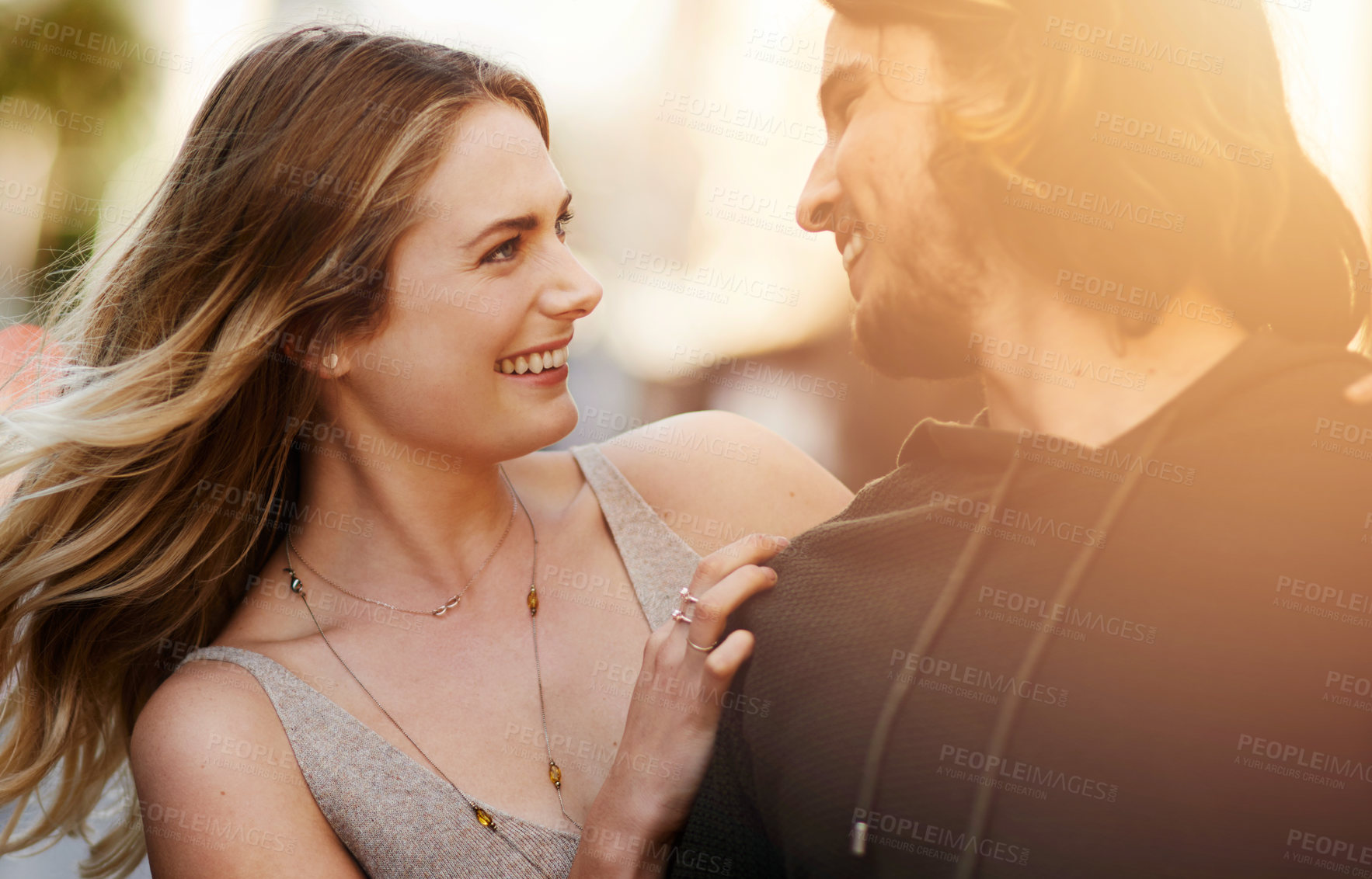 Buy stock photo Couple, walking and smile in city with lens flare for happiness, commitment and loyalty as partner. Man, woman and love together in urban street for relationship, date and romance with trust or care
