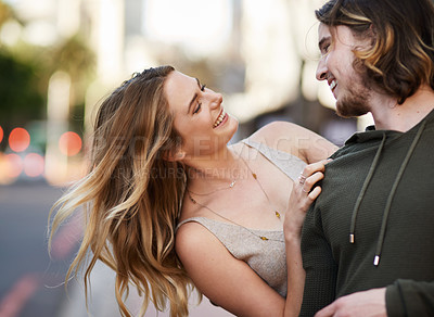 Buy stock photo Couple, trust and happy in city with smile for love, commitment and loyalty as partner. Man, woman and walking together in urban street for relationship, date and romance with joke or happiness
