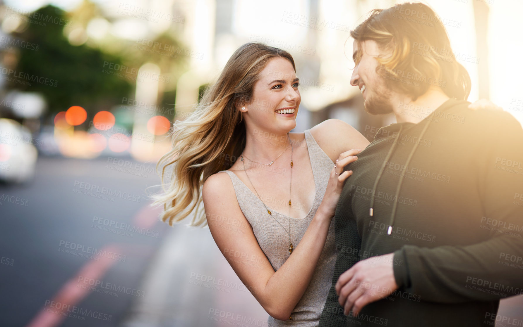 Buy stock photo Couple, romance and smile in city with lens flare for love, commitment and loyalty as partner. Man, woman and travel together in urban street for relationship, date and happy with trust or care
