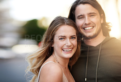 Buy stock photo Portrait of a happy young couple out in the city together