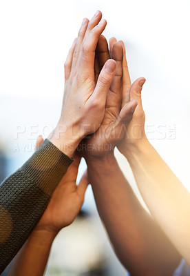 Buy stock photo Cropped shot of a group of people giving each other a high five