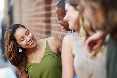 Buy stock photo Shot of a group of friends having fun outdoors over the weekend