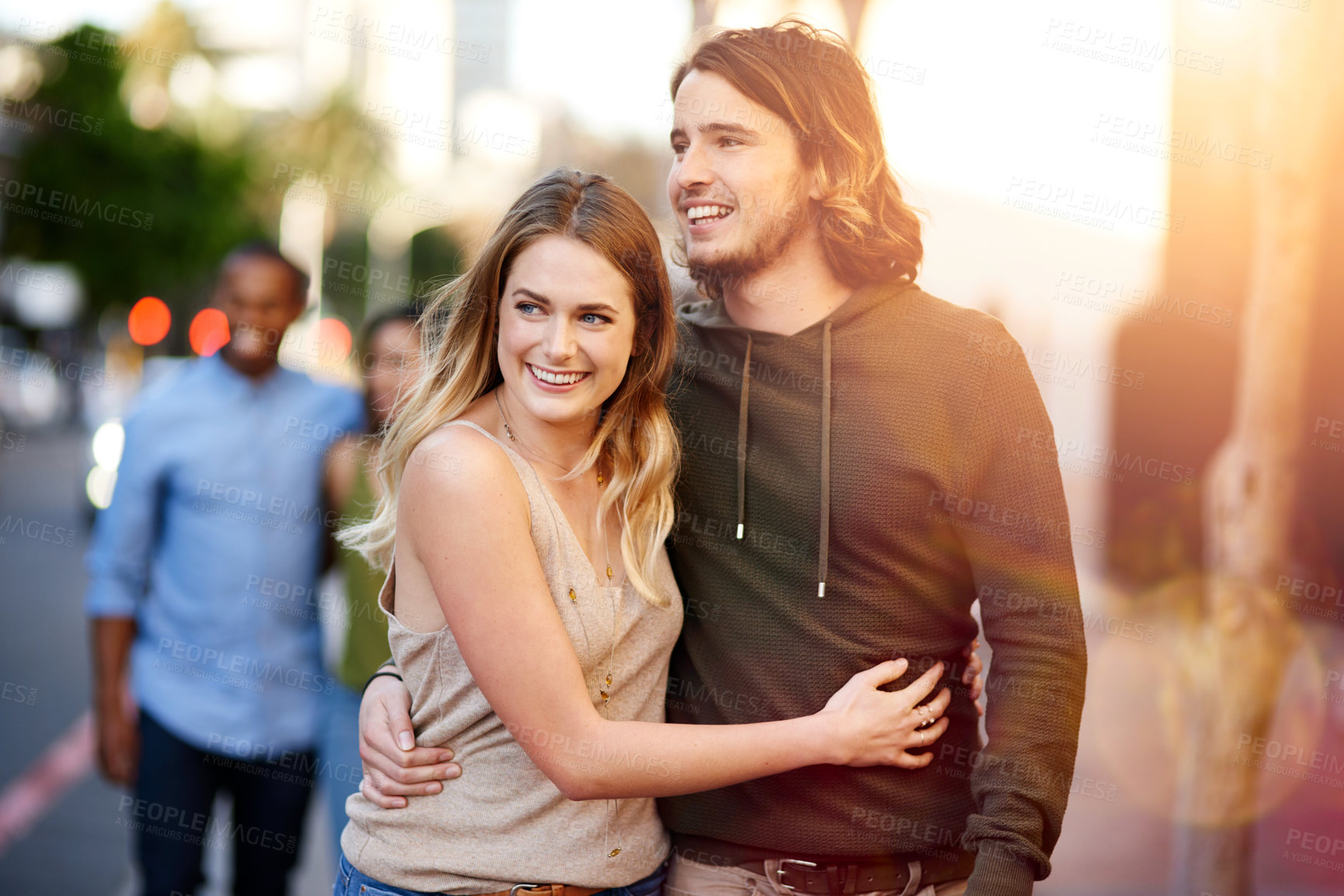 Buy stock photo Shot of two happy young couples taking a walk through the city