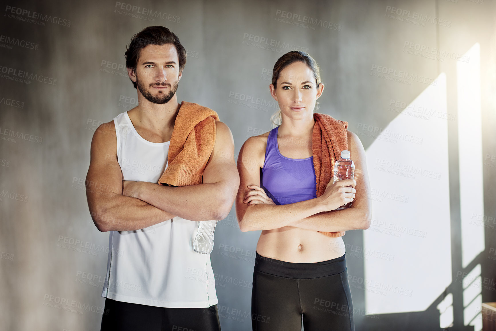 Buy stock photo Towel, fitness and portrait of couple in gym for intense training, exercise and cardio workout. Sports, personal trainer and man and woman for wellness, healthy body and performance with water