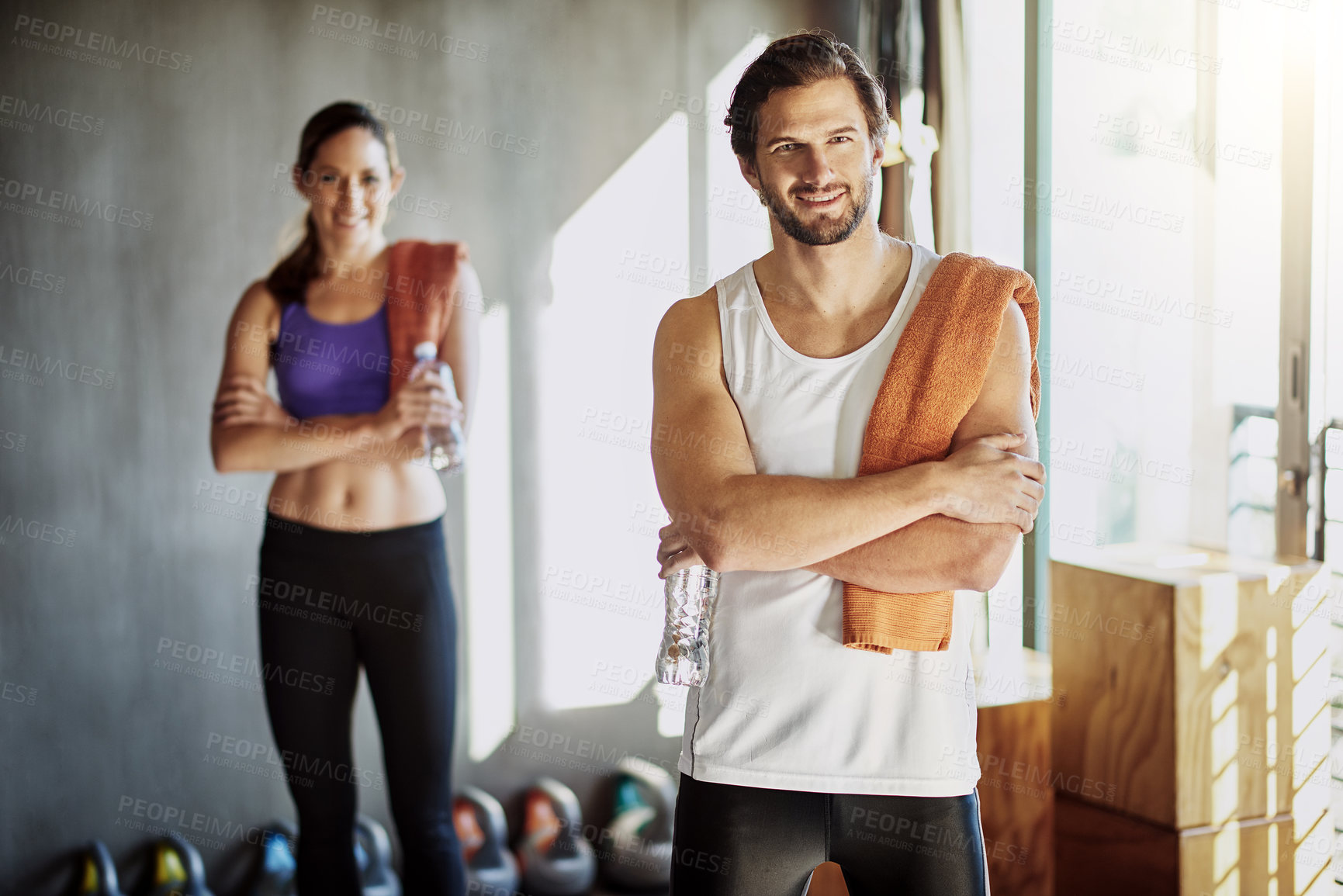 Buy stock photo Towel, fitness and portrait of couple in gym for training, exercise and cardio workout. Sports, personal trainer and happy man and woman for wellness, healthy body and performance with water bottle