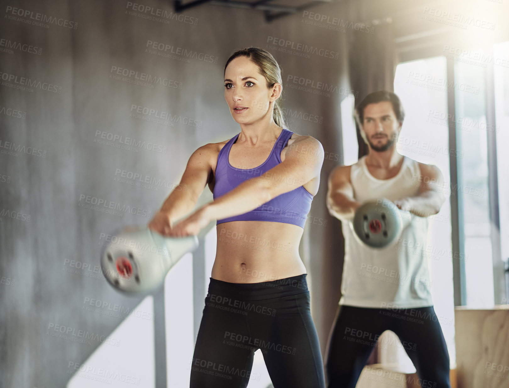 Buy stock photo People, kettlebell and training together at gym, weightlifting and equipment for power workout. Man, woman and coach for athletes in health club, cardio fitness and friends support for exercise