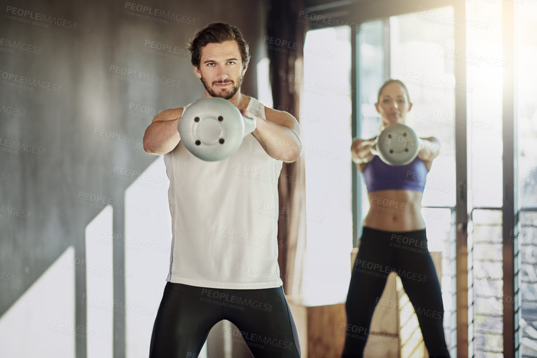 Buy stock photo People, kettlebell and exercise together at gym, weightlifting and equipment for swing workout. Man, woman and coach for athletes in health club, cardio fitness and friends support for challenge