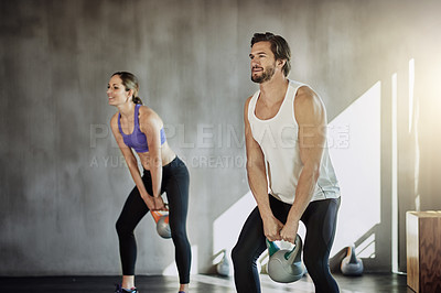 Buy stock photo People, kettlebell and fitness training at gym, weightlifting and equipment for power workout. Man, woman and coach for athletes in health club, teamwork challenge and friends support for exercise