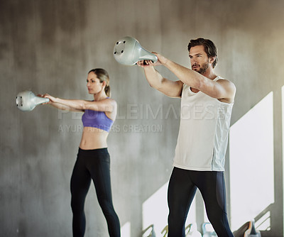 Buy stock photo Weights, man and woman in gym with kettlebell, fitness and power at workout challenge together. Couple, sports club and personal trainer with training, muscle development and healthy body exercise