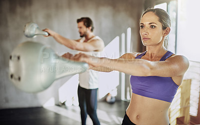 Buy stock photo Exercise, man and woman in gym with kettlebell, training and power at workout challenge together. Couple, sports partner or personal trainer with weights, muscle development and healthy body fitness.