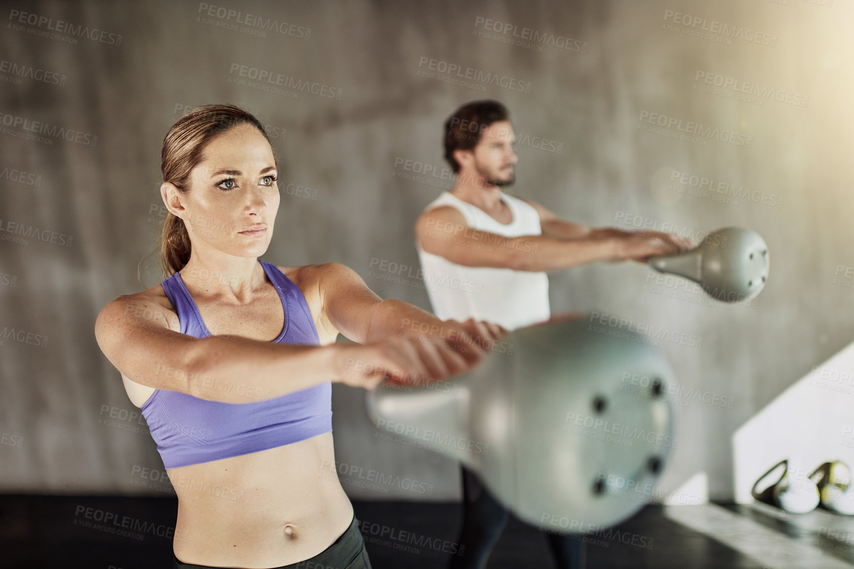 Buy stock photo Training, power and couple in gym with kettlebell, fitness and workout challenge together at sports club. Man, woman and personal trainer with weights, muscle development and healthy body exercise.
