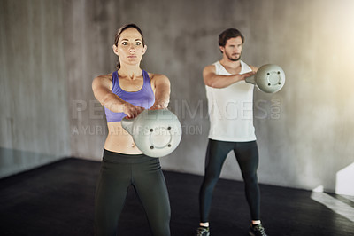 Buy stock photo Training, sports and couple in gym with kettlebell, power and workout challenge together at fitness club. Man, woman and personal trainer with weights, muscle development and healthy body exercise.