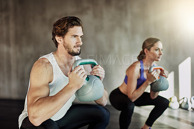 Buy stock photo Fitness, squat and couple in gym with kettlebell, power training and workout challenge together at sports club. Man, woman or personal trainer with muscle development, healthy body and exercise.