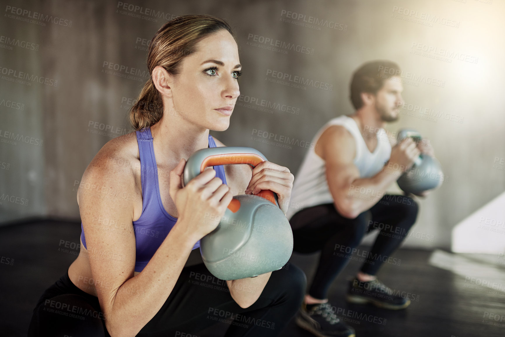 Buy stock photo Power, squat and couple in gym with kettlebell, fitness training and workout challenge together at sports club. Man, woman or personal trainer with muscle development, healthy body and exercise.