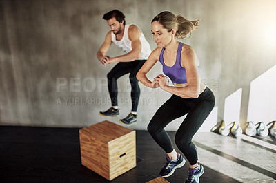 Buy stock photo Jump, man and woman in gym with box, fitness and power training at workout challenge together. Couple, sports club and personal trainer with balance, muscle development and healthy body exercise