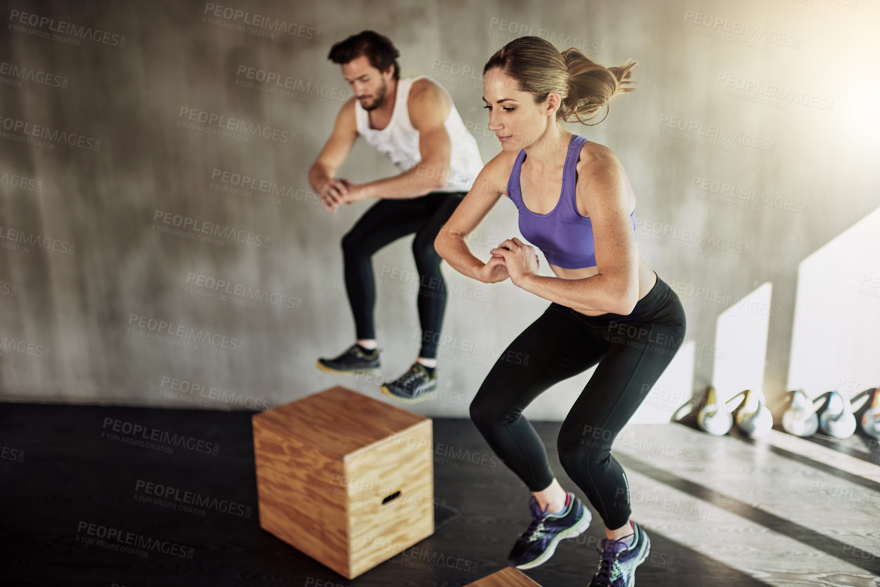 Buy stock photo Jump, man and woman in gym with box, fitness and power training at workout challenge together. Couple, sports club and personal trainer with balance, muscle development and healthy body exercise