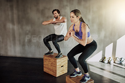 Buy stock photo Jump, training and couple in gym with box, power and fitness at workout challenge together. Man, woman and personal trainer with balance, muscle development and healthy body exercise at sports club