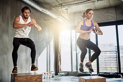 Buy stock photo Jumping, training and couple in gym with box, power and fitness at workout challenge together. Man, woman and personal trainer with balance, muscle development or healthy body exercise at sports club