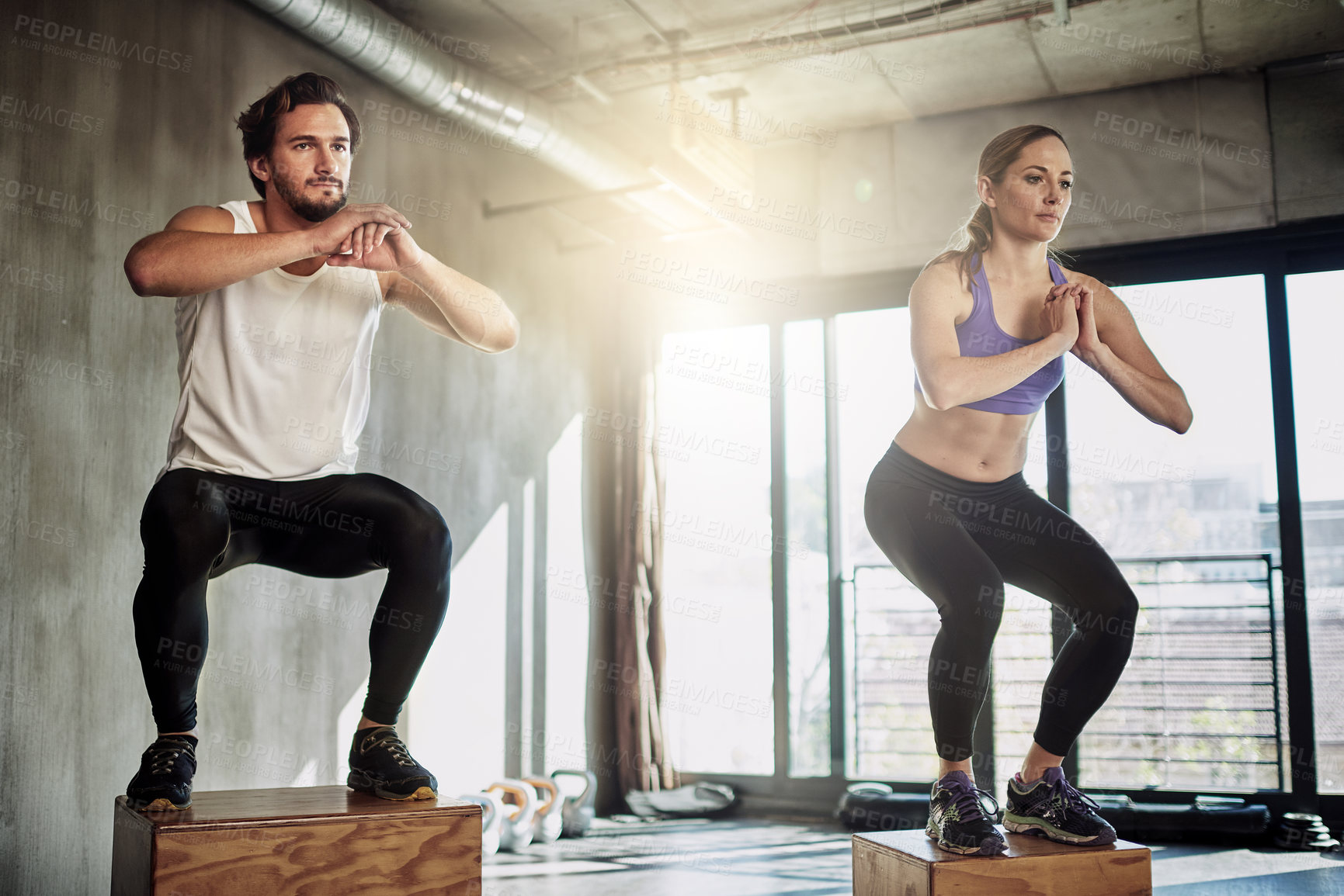Buy stock photo Jump, fitness and couple in training with box, power and gym for workout challenge together. Man, woman and personal trainer with balance, muscle development and healthy body exercise at sports club