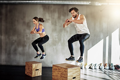 Buy stock photo Jump, fitness and couple in workout with box, power and training challenge at gym together. Man, woman and personal trainer with balance, muscle development and healthy body exercise at sports club