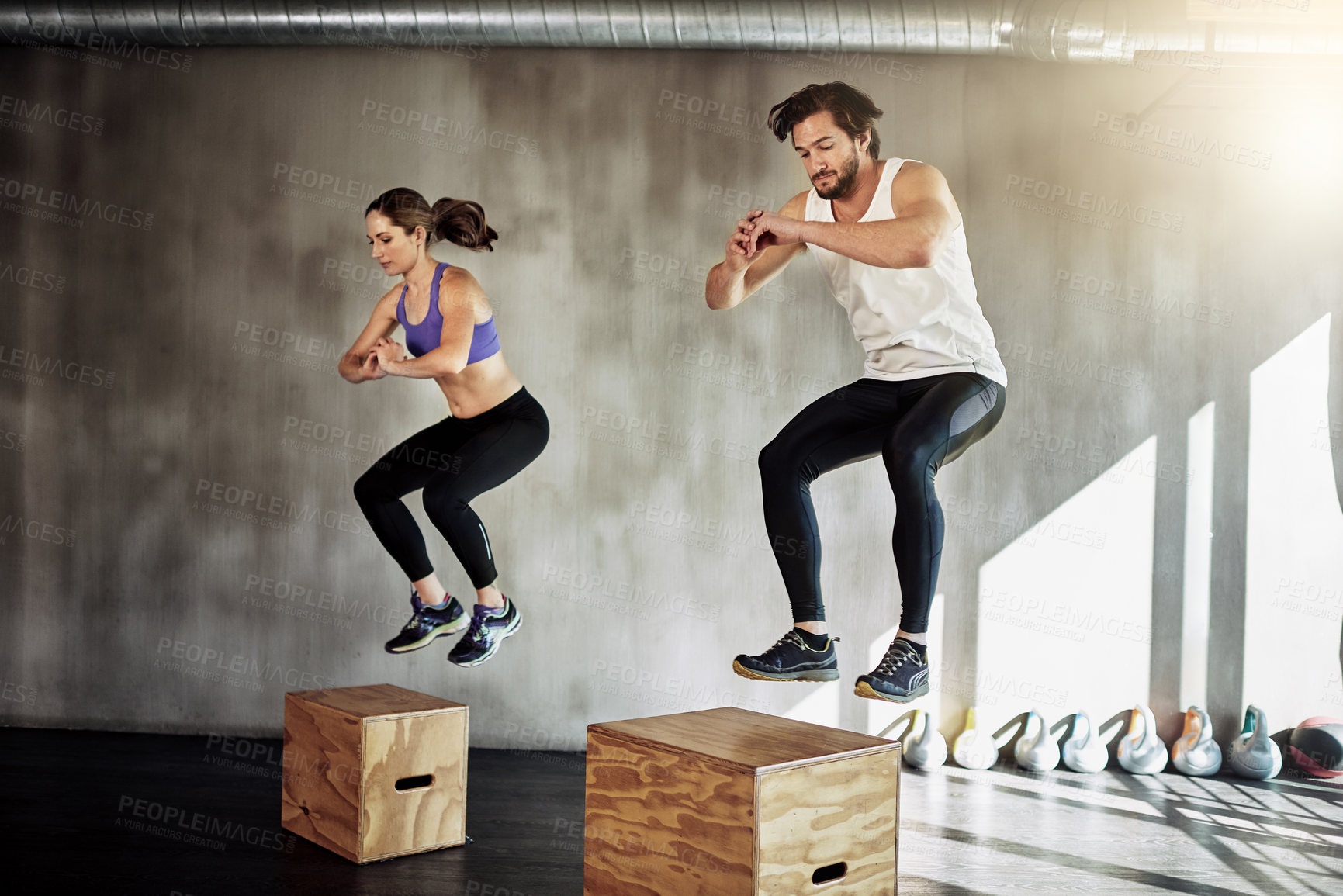 Buy stock photo Jump, fitness and couple in workout with box, power and training challenge at gym together. Man, woman and personal trainer with balance, muscle development and healthy body exercise at sports club