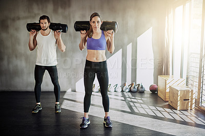 Buy stock photo Man, woman and sandbag workout or gym exercise for healthy muscle fitness, weights or strength. Personal trainer, friends and athlete equipment or power teamwork with support, discipline or class