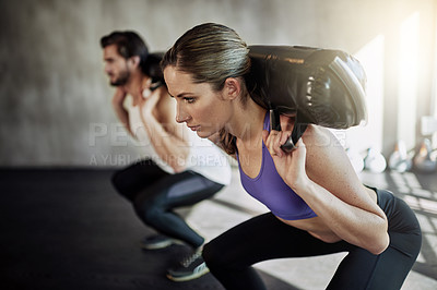Buy stock photo Squat, sandbag and fitness exercise or gym workout with personal trainer for training, weights or strengths. Man, woman and glutes routine for muscle building with leg goals, together or equipment
